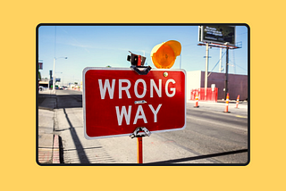 Red sign saying “Wrong way”