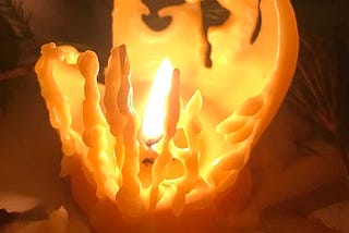 Candle flame inside melted candle