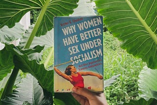 The book ‘Why Women Have Better Sex Under Socialism’ in the backdrop of some monstrous Alocasia.
