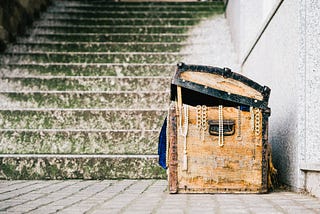 a golden treasure chest at the bottom of a stone staircase