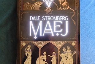 cover of MAEJ by Dale Stromberg. A ship, a gryphon, and a mysterious scene with silhouettes of women interacting.