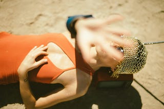 Woman lying in scorching sunlight