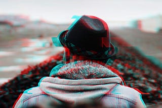 A person with hat looking at the crossroads, the image has a glitch effect.