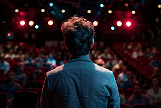 man standing with his back to the camera, facing a large crowd