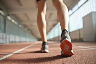 a man’s legs, preparing for a run, wearing running shoes