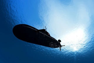 What makes a Submarine sink, but not enough to reach the ground?