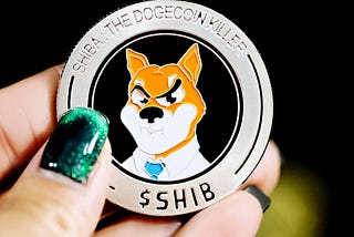 one Shiba Inu coin held in a woman’s hand