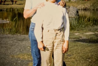 A young couple posing for a portrait on their honeymoon.