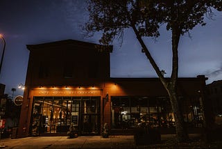 Photo of a small boutique hotel at night.