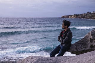 Man looking at the sea connecting to his intuition.