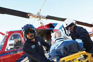 Picture of people removing a patient from a medical helicopter.