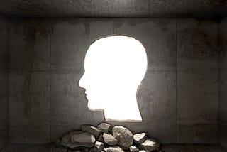 Head shape cut out of a wall, letting light in.