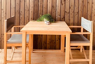 An image of a table with two empty chairs facing each other.