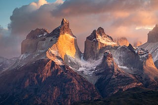 “Sunrise” An epic view of Torres del Paine. In the early morning, when conditions are just right, the first sunlight beautifully highlights parts of the mountains.