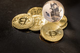 Glass globe and Bitcoin Cryptocurrency