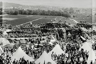 Napoleon, to the left, looks over an encampment of his troops