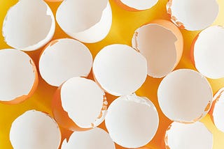 eggs shells open against yellow background