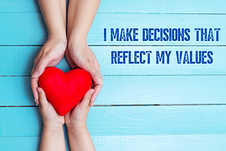 light blue wood background with 2 pairs of hands holding a red heart between them. Words on right in dark blue: I make decisions that reflect my values.