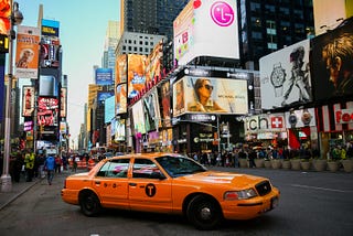 Billboards and a yellow cab in New York