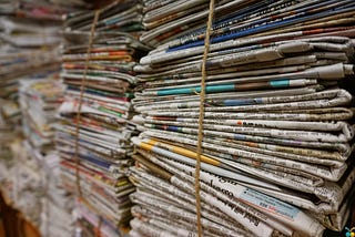 stacks of newspapers folded and bound with twine