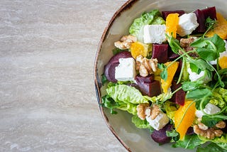 Healthy salad with white cheese, beetroot, oranges and walnuts.