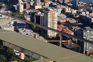 Photo of steel structure high above a city.