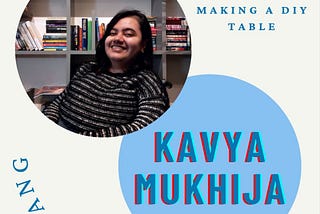 This is a poster about the piece with a photo of Kavya, who is dressed in black and white stripped sweater, sitting on a wheelchair with a book shelf full of books, and looking at the camera, with her name diagonally below that. The name of the piece —Ten Reflections While making a DIY table is written at the top right corner. On the left bottom is the word Dislang written in stylized formatting.