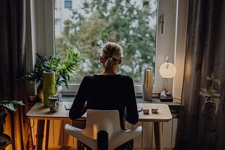 Woman working at desk by window