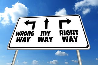 A sign with arrow to left says “wrong way”. Arrow to right says “right way”. Arrow pointing up says “my way”.