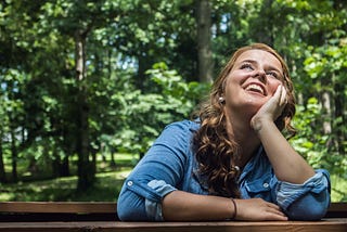 Woman looking up smiling.