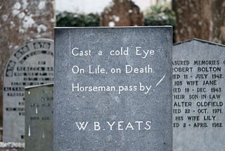 Headstone in a cemetery reads “Cast a cold Eye, On Life On Death. Horseman pass by -W.B. Yeats”