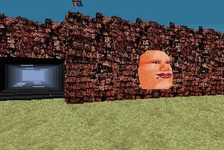 A face protrudes from a wall next to a tunnel
