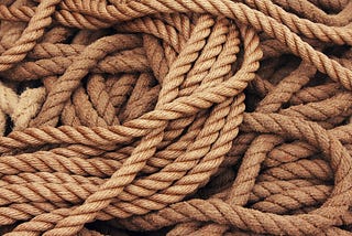 Image of tangled boat mooring ropes as a representation of something difficult to solve.
