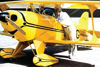 A small yellow biplane.