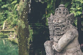 a ruin state of a buddhist demon guarding an unseen temple