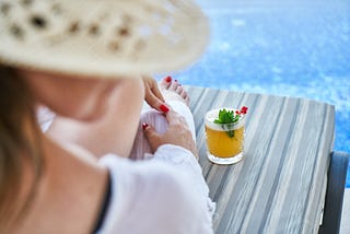 Woman drinking cocktail at the beach