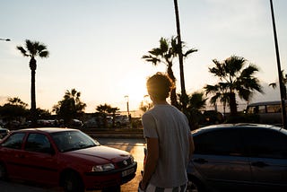 A man walk on Beirut’s seafront at sunset. Photo credit: Etienne Boulanger