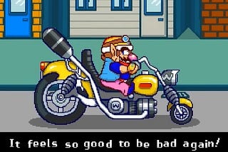 Screenshot of Wario on the Wario Bike from WarioWare: Touched! Text reads: It feels so good to be bad again!