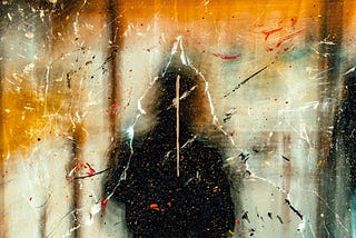 A dim silhouette of a person around a gray and orange textured art piece.