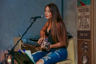 A woman playing a guitar. The lack of interest in alcohol is starting to hit the music industry.