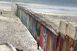 The border wall extends into the Pacific Ocean