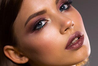 Woman with beautiful makeup, maroon eyeshadow and lipstick