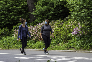 Women walking wearing masks
