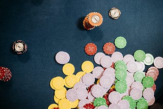 Casino tokens scattered on a gaming table.