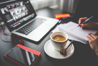 Working at desk with laptop, planner and coffee by Picjumbo.