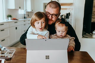 Father works from home with his two kids.