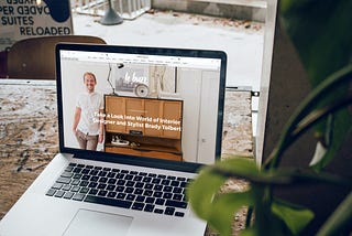 Image of a laptop featuring a web page about an interior designer and stylist.