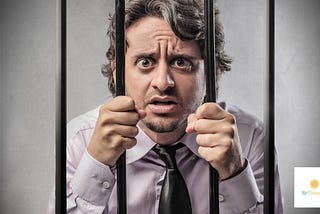 man behind jail bars looking anxious and surprised