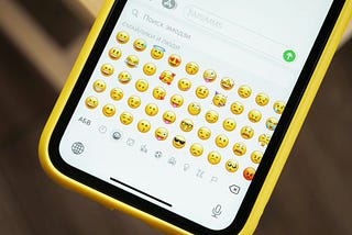 The emoticons section in a qwerty keyboard of a cellphone.