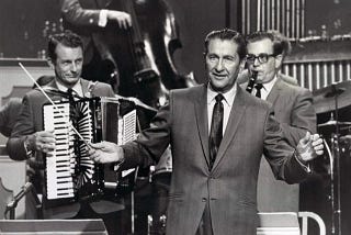 Lawrence Welk conducting his orchestra. Photo by ABC-TV, Public domain, via Wikimedia Commons